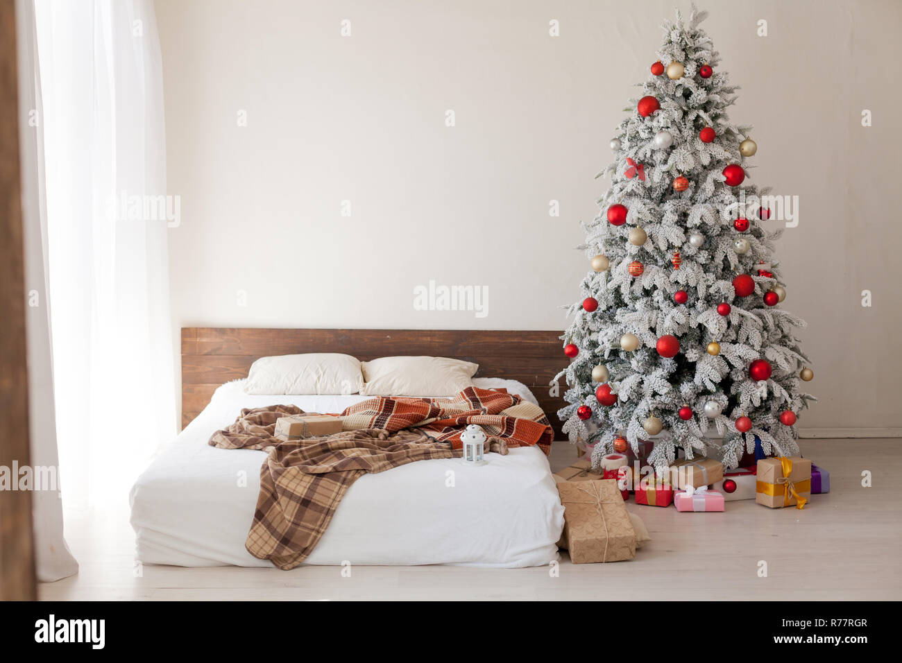Cozy bed with Christmas pillows decorated with Christmas decor Stock Photo  - Alamy