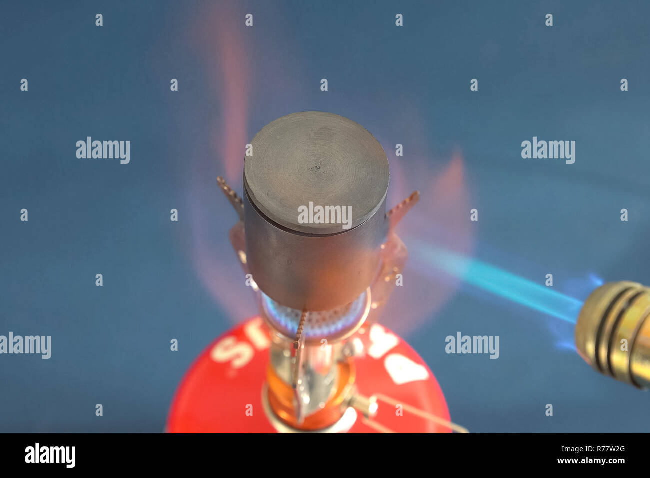 Melting of aluminum on the burner. Conducting physical experiments with aluminum Stock Photo