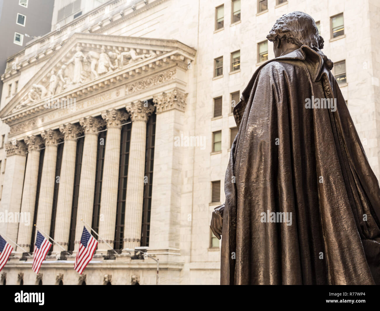 View from Federal Hall of the statue of George Washington and the Stock Exchange building in Wall Street, New York City. Stock Photo