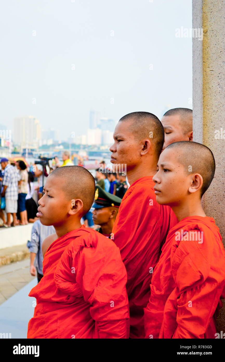 Bangkok, Thailand, 01 november 2016: group of young bhuddist priests with shaven head watching in city with traditional orange dress Stock Photo