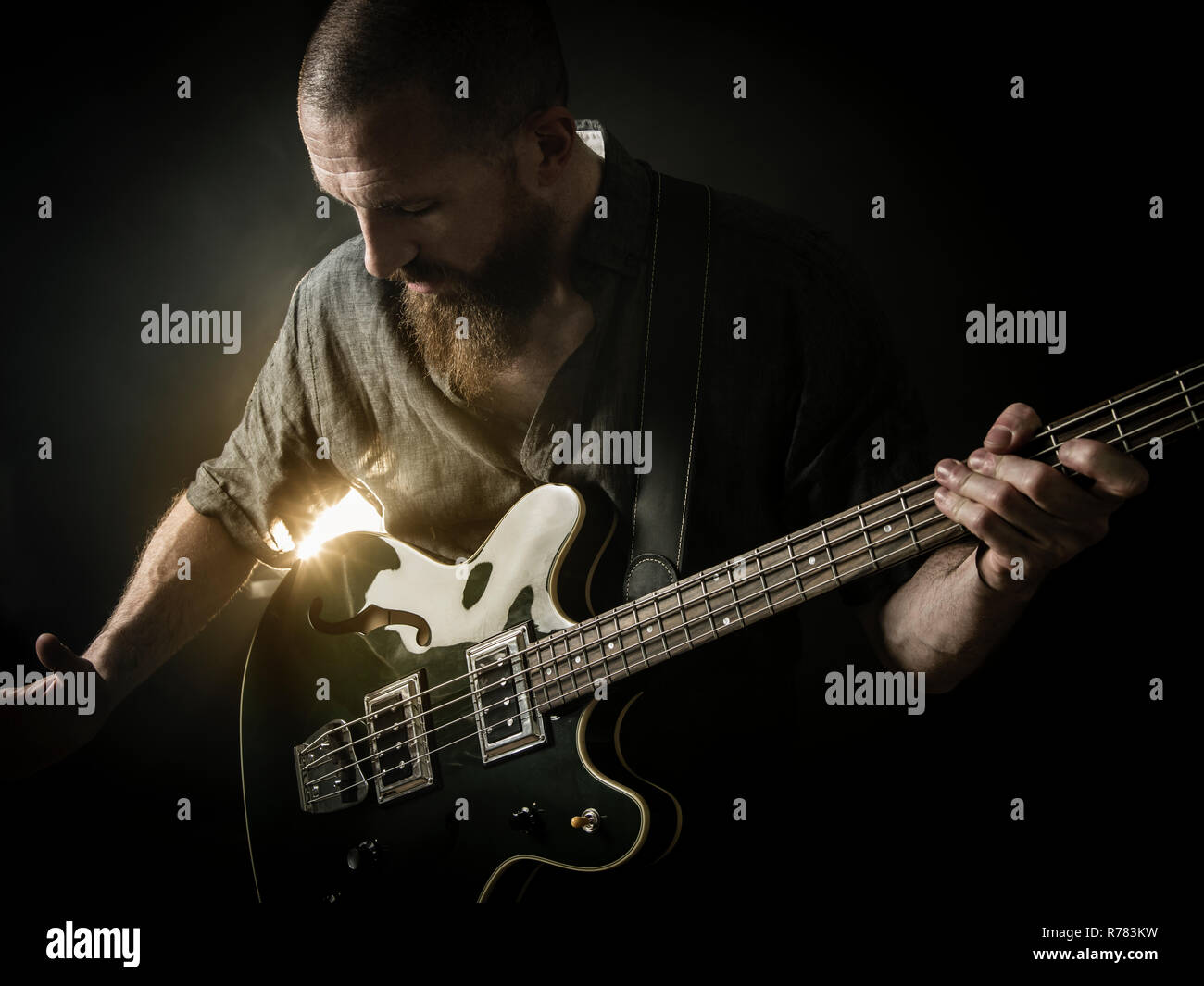 Bearded man playing bass guitar Stock Photo