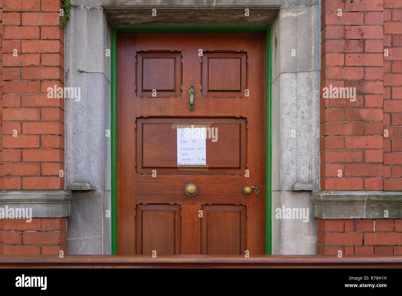 Bank Door with blue on white closed sign due to faulty safe. Stock Photo
