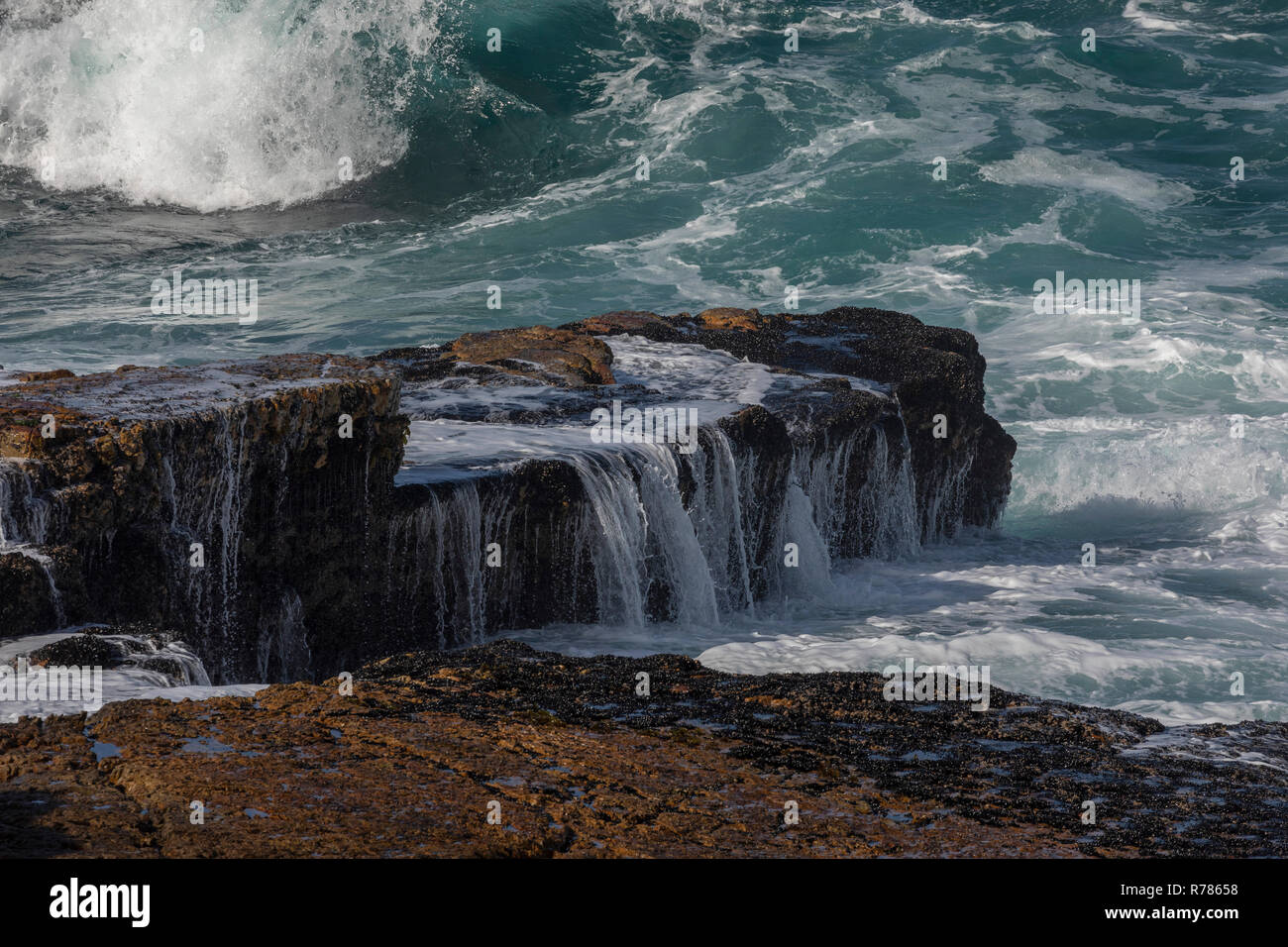 Waves breaking over the rocks at Hermanus, Cape, South Africa. Stock Photo