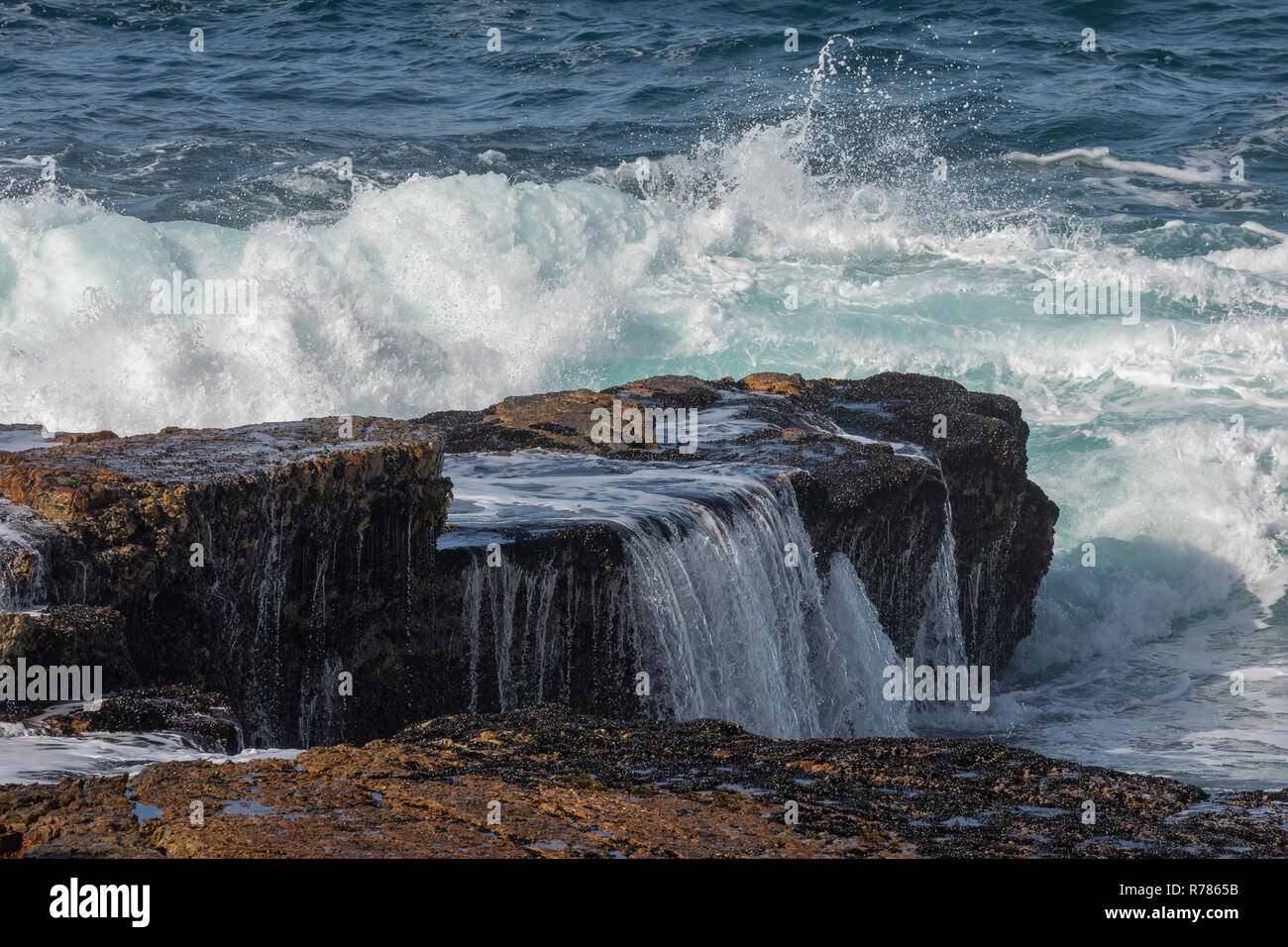 Waves breaking over the rocks at Hermanus, Cape, South Africa. Stock Photo