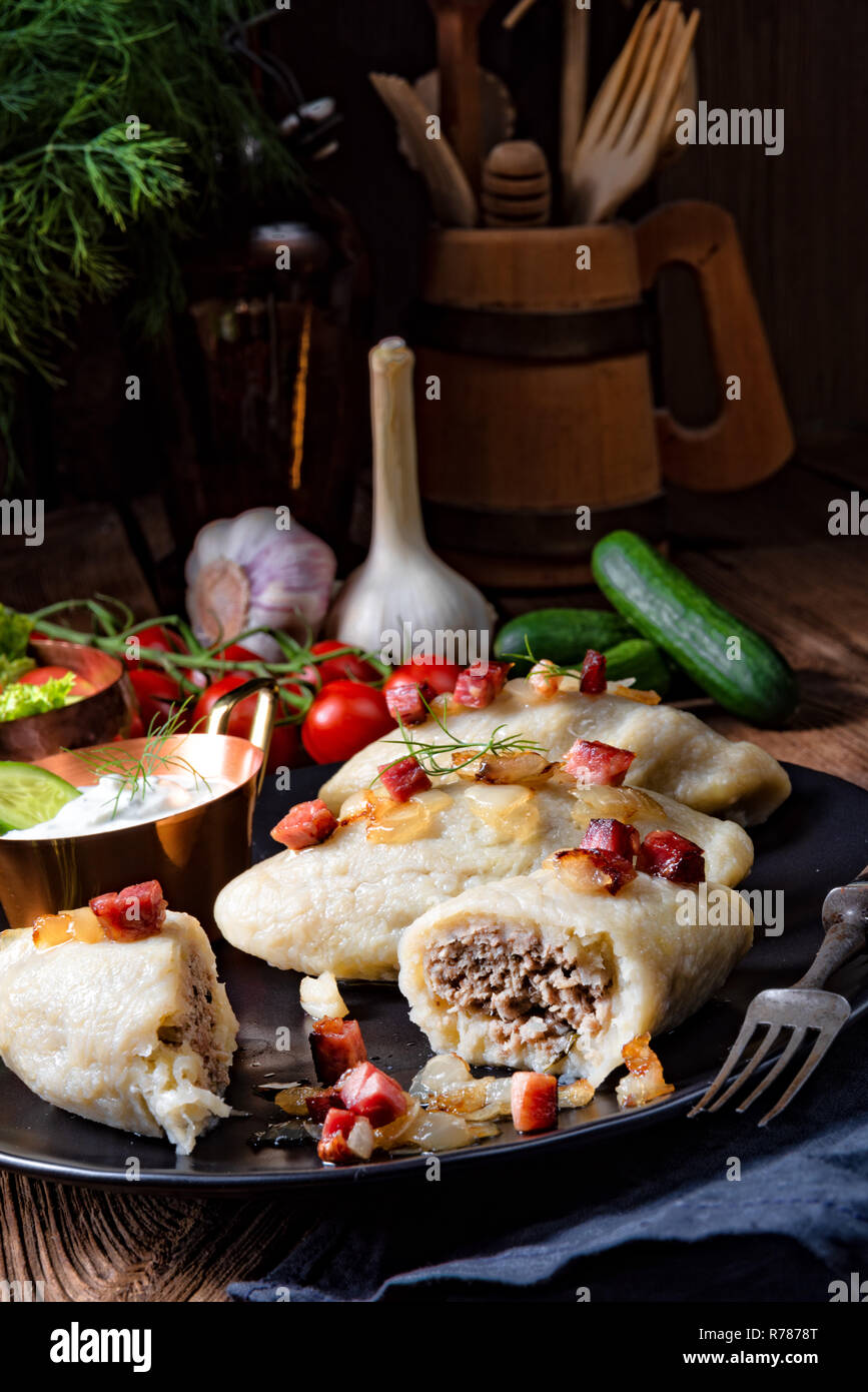 rustic cepelinai,a specialty of lithuanian and polish cuisine. Stock Photo