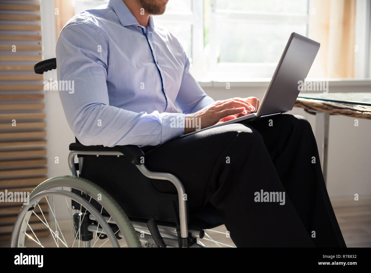 Disabled Businessman Using Laptop Stock Photo