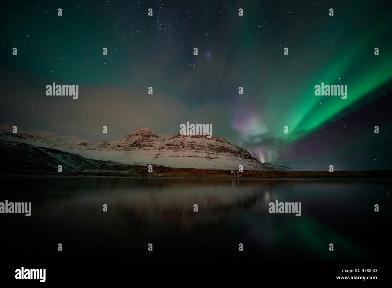 Aurora Borealis, the Northern Lights, over a hillside on the west coast