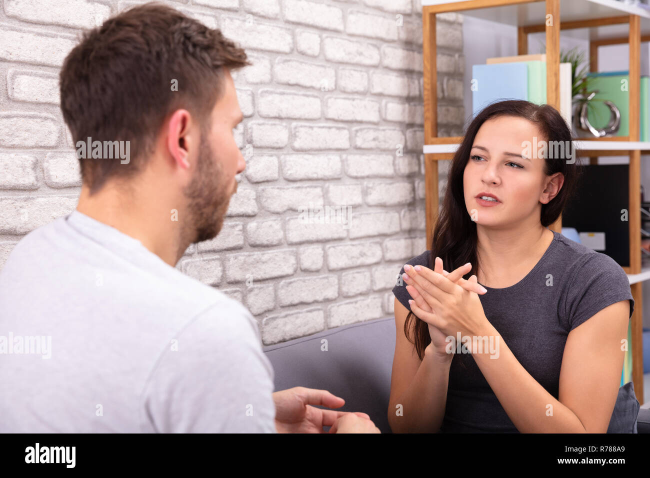 Two people talking sofa man woman hi-res stock photography and images ...