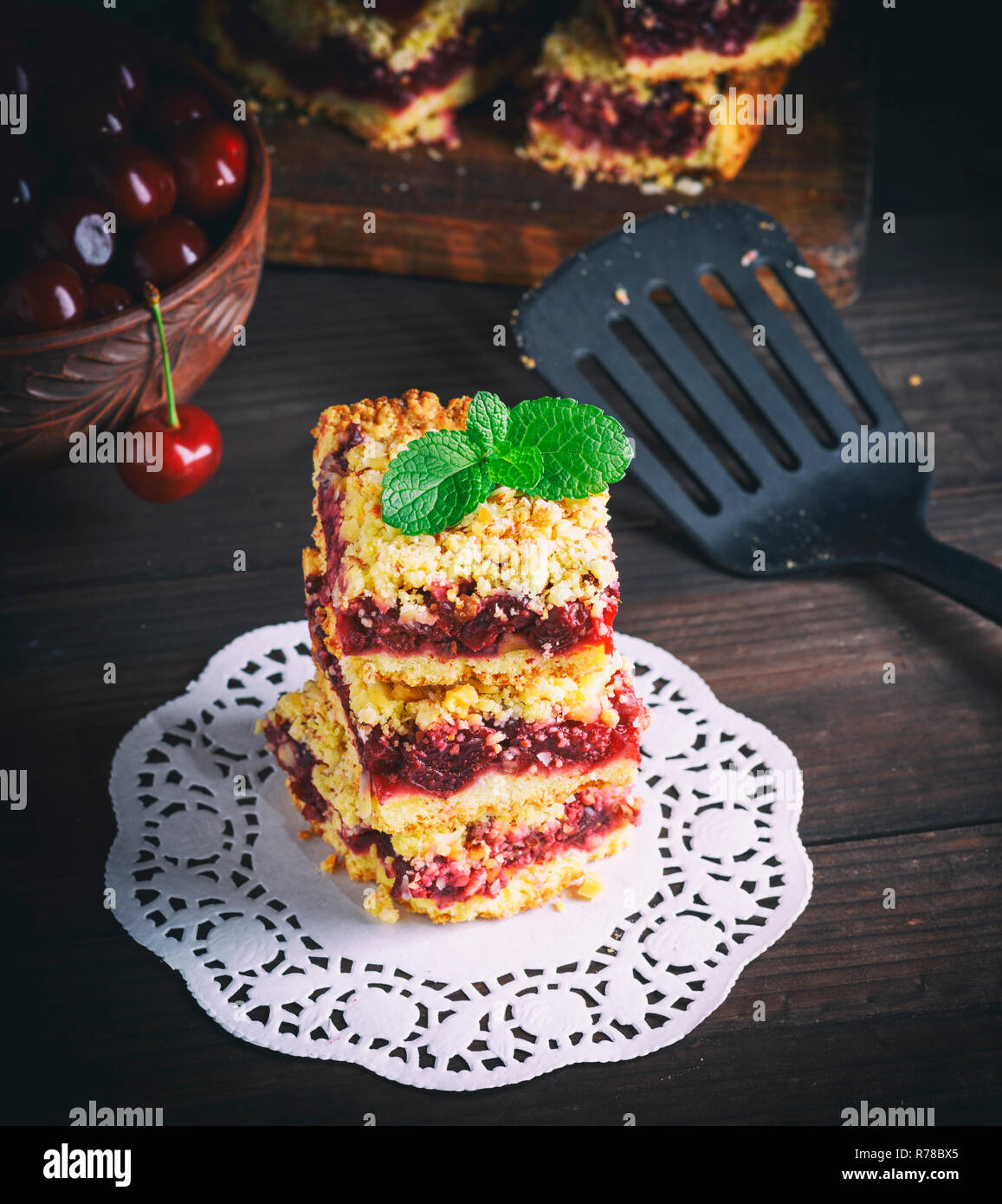 stack of baked crumble cake with cherry Stock Photo