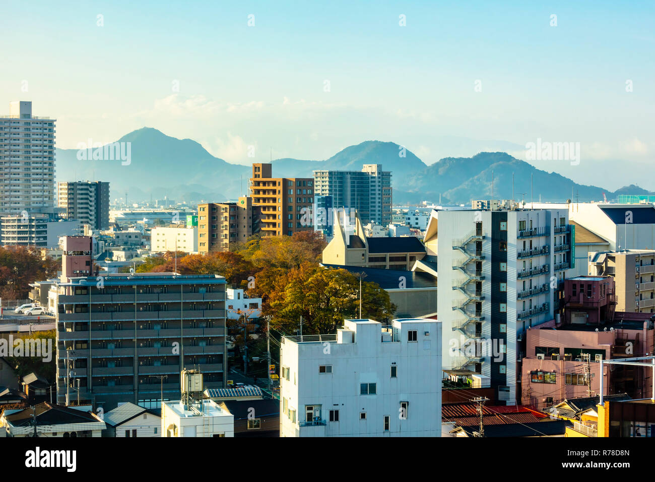 Mishima, Shizuoka / Japan - December 1 2018: Mishima modern city centre near JR railway station dense buildings with mountains in background Stock Photo