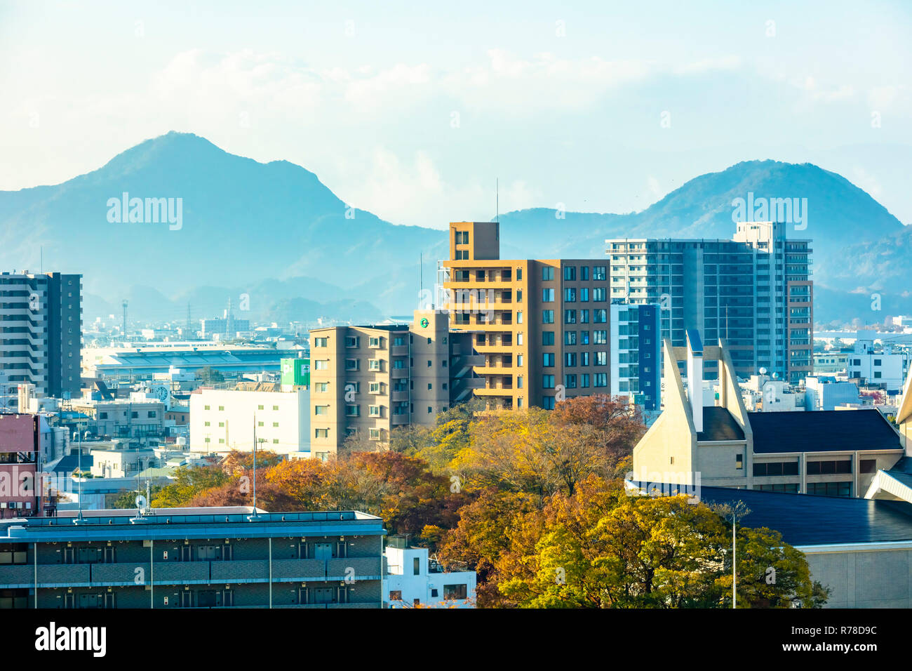 Mishima, Shizuoka / Japan - December 1 2018: Mishima modern city centre near JR railway station dense buildings with mountains in background Stock Photo
