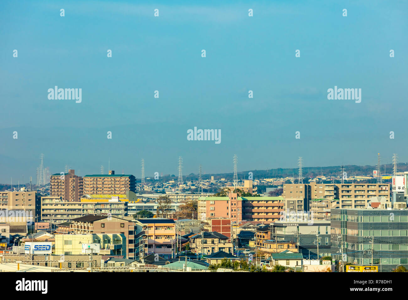 Mishima, Shizuoka / Japan - December 1 2018: Mishima modern city centre near JR railway station dense buildings with mountains in background Stock Photo