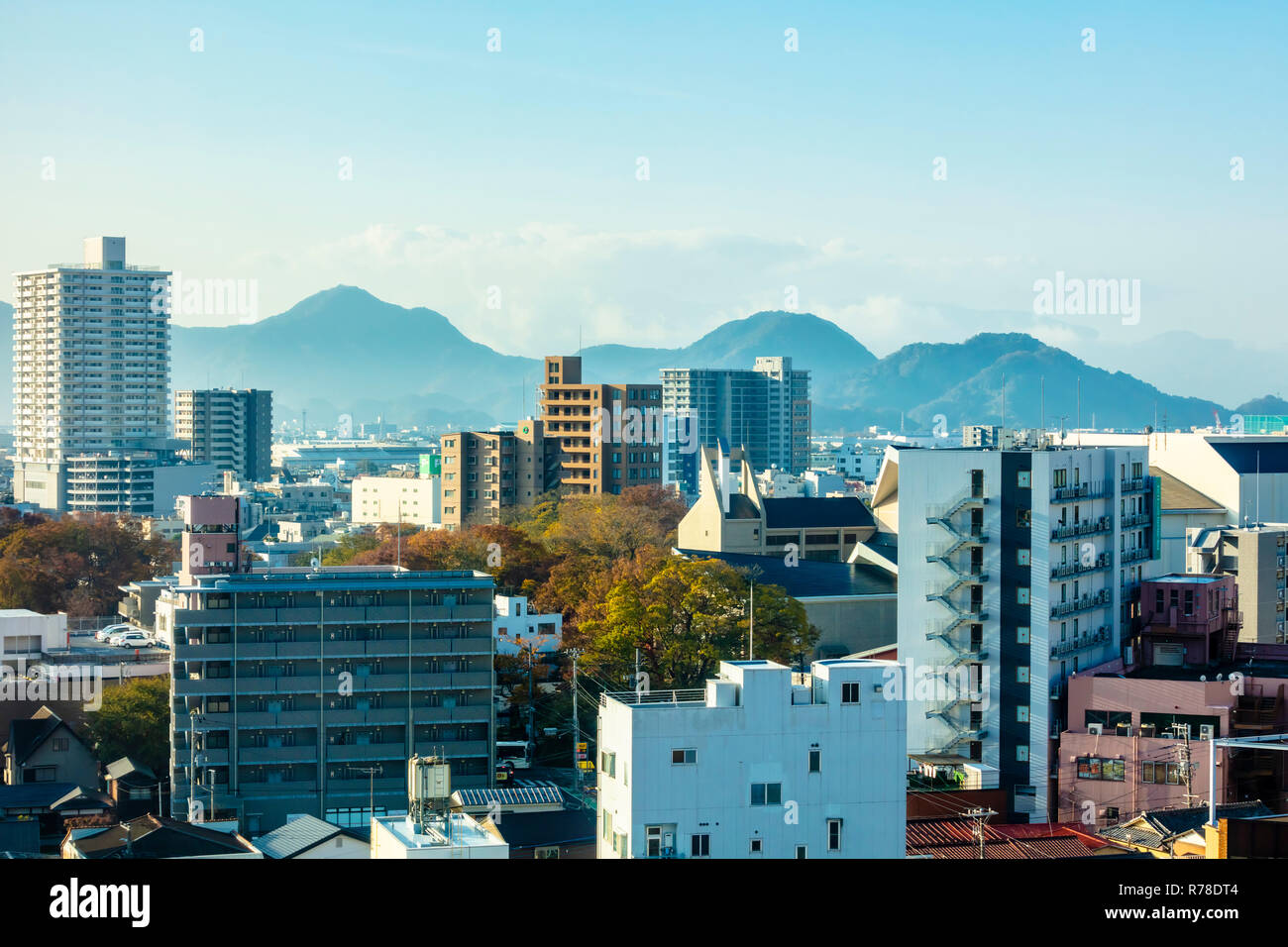 Mishima, Shizuoka / Japan - December 1 2018: Mishima modern city centre near JR railway station dense buildings with mountains in background Stock Photo