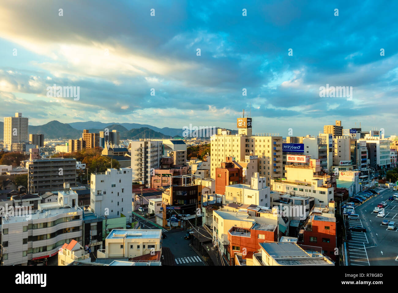 Mishima, Shizuoka / Japan - December 1 2018: Mishima modern city centre near JR railway station dense buildings with mountains in background Stock Photo