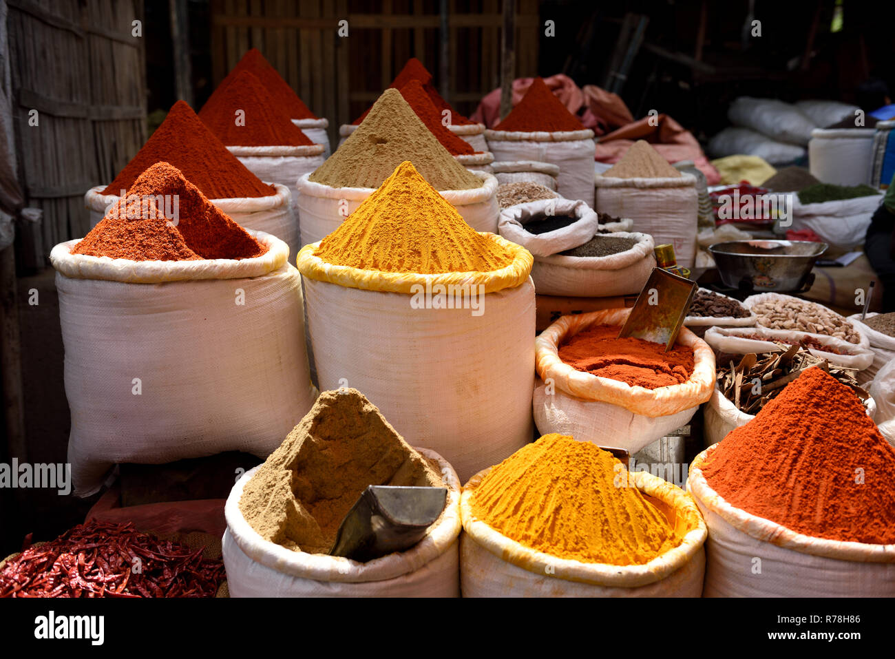 Baskets of fresh raw essential Indian spices, chili, coriander and turmeric powders in a spice market in Jaipur, Rajasthan, India. Stock Photo
