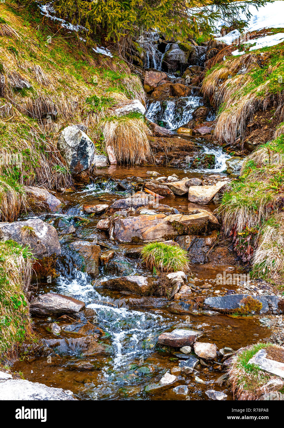 Spring creek in Bettmeralp village in Swiss Alps Stock Photo