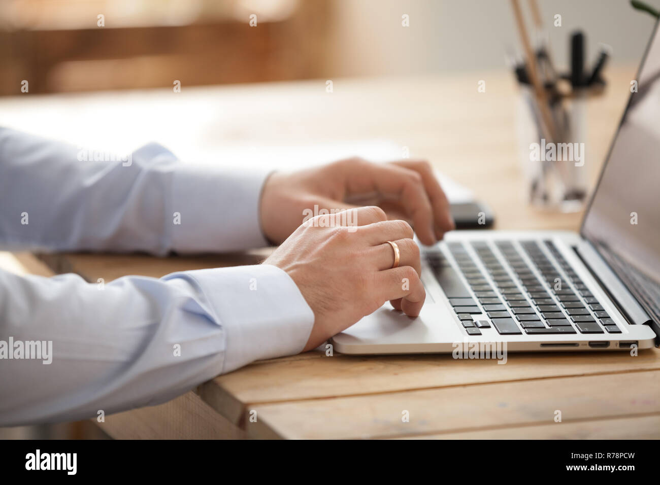 Close up of businessman using laptop browsing internet Stock Photo