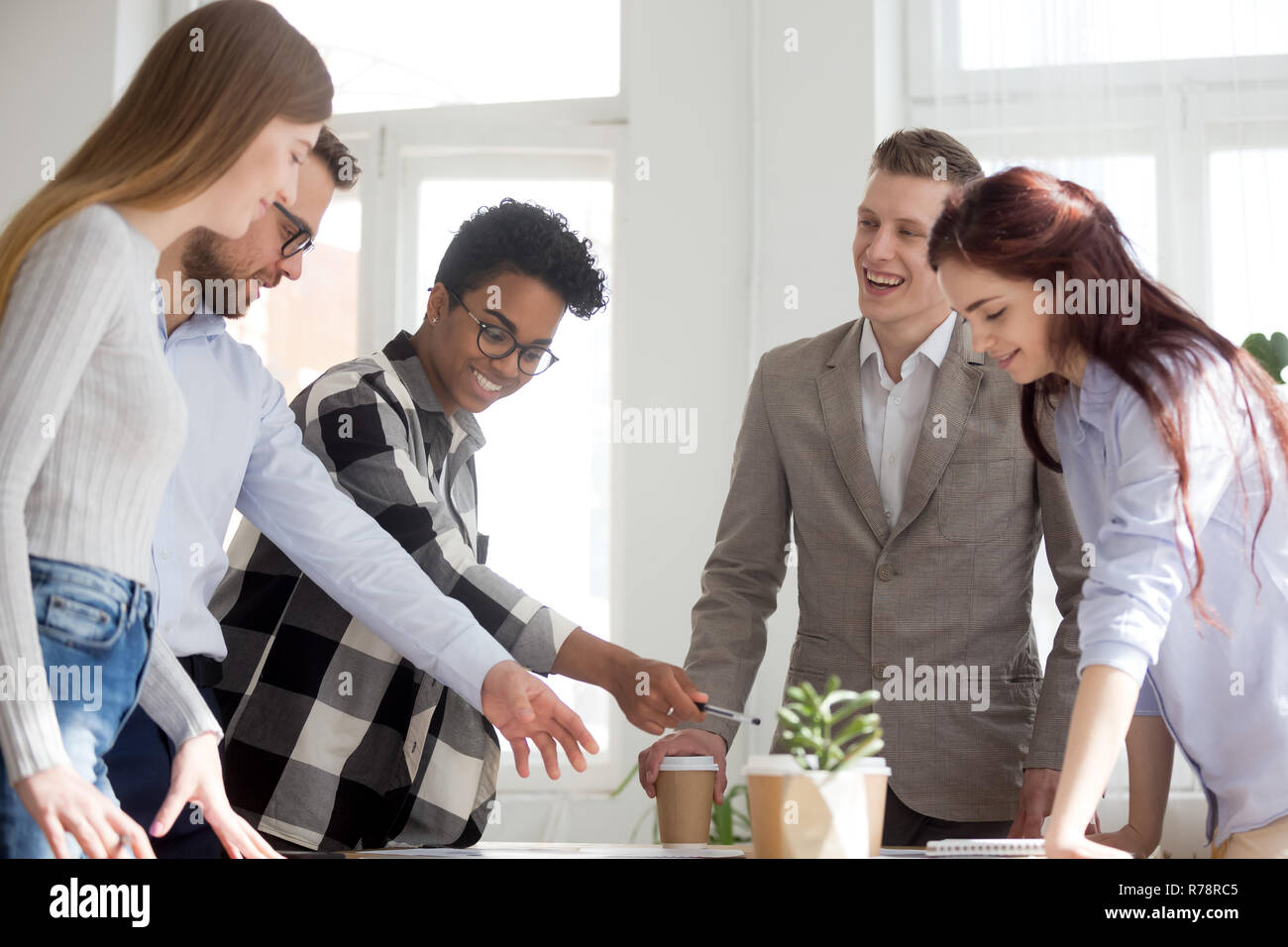 Excited diverse employees have fun brainstorming in office Stock Photo ...