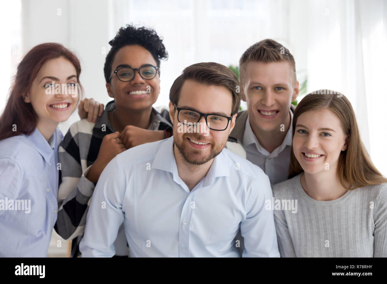 Portrait of smiling diverse millennial team posing together Stock Photo ...