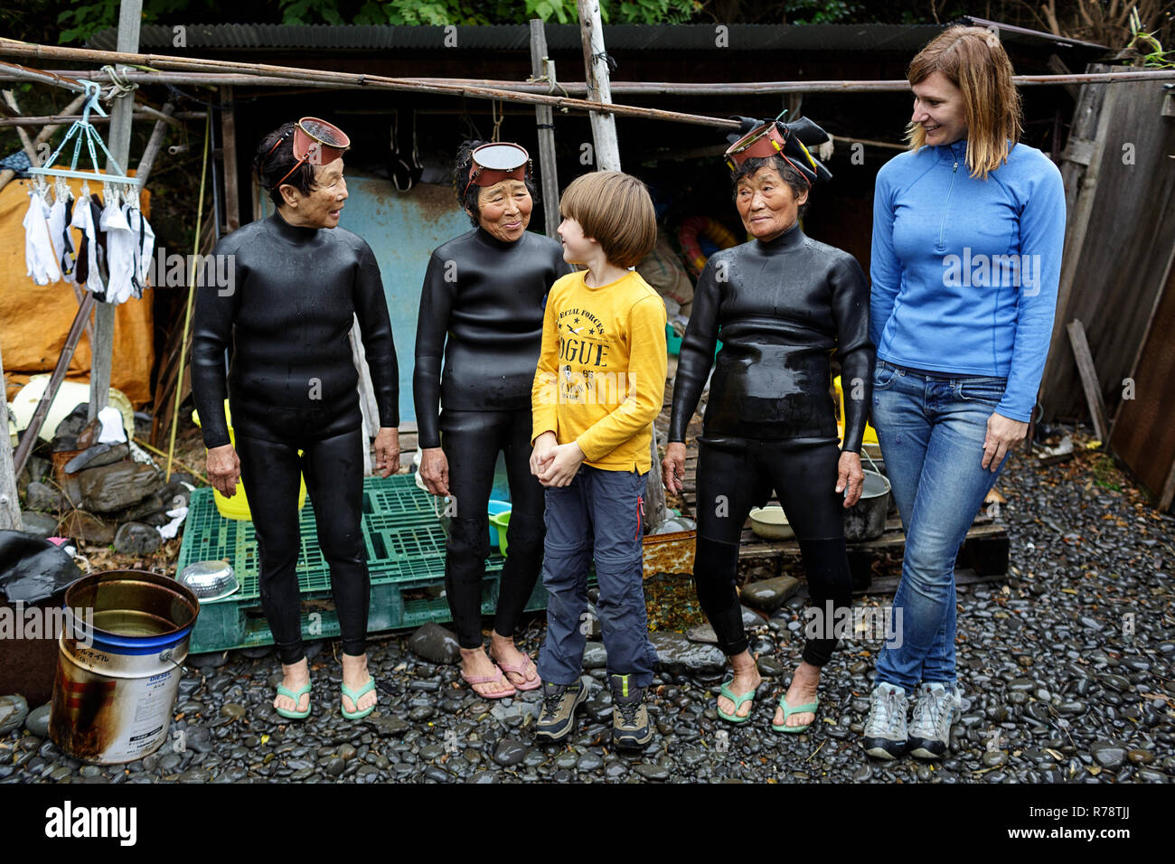 Mother and son making friends and taking a group photo with women Ama  divers, Mie, Japan Stock Photo - Alamy