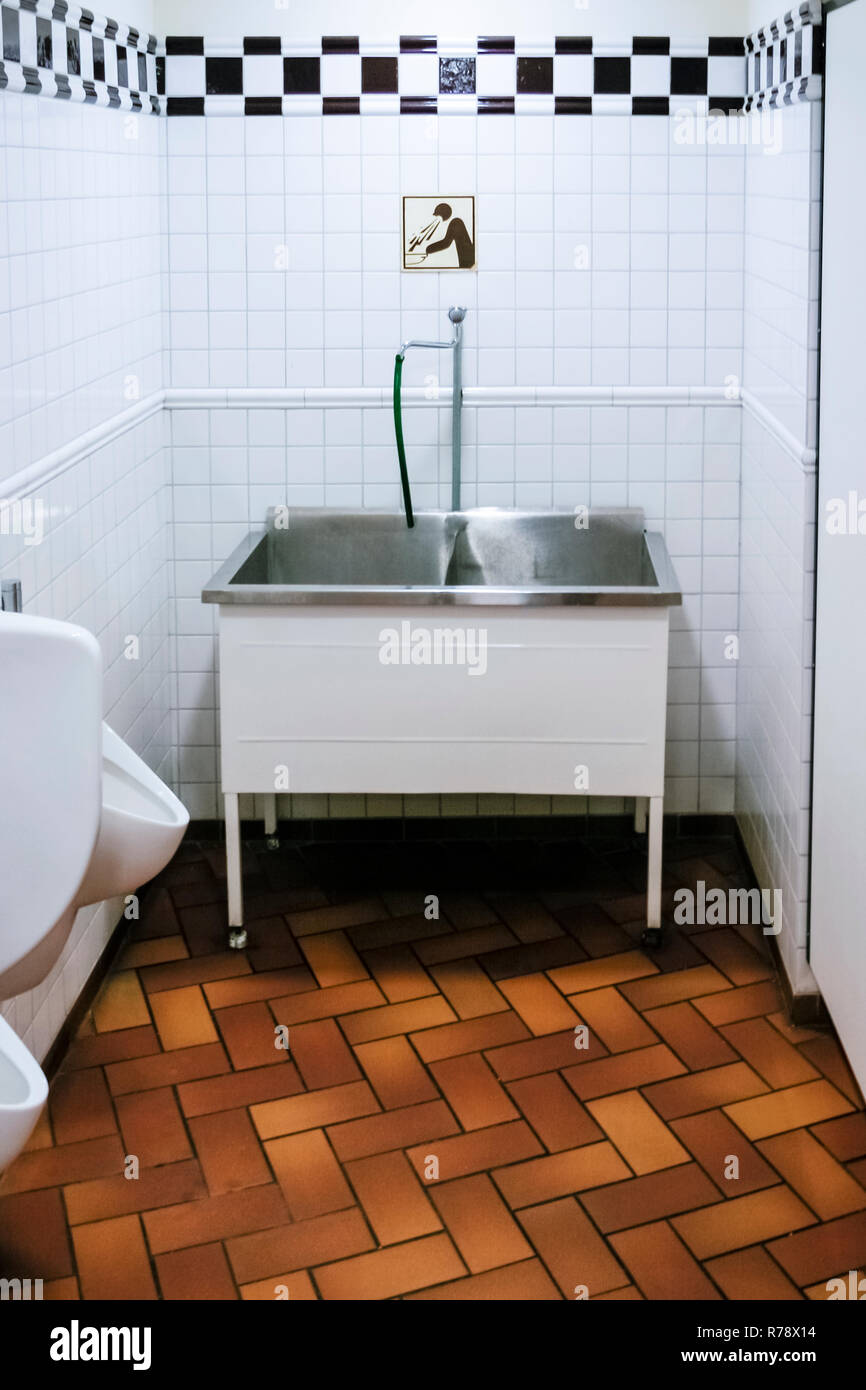 A vomit sink in the mens toilet of a bar in Krakow, poland Stock Photo