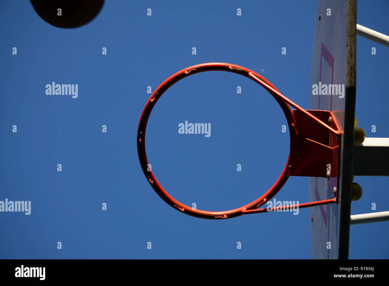 Close up on a netball hoop with net against grey sky Stock Photo