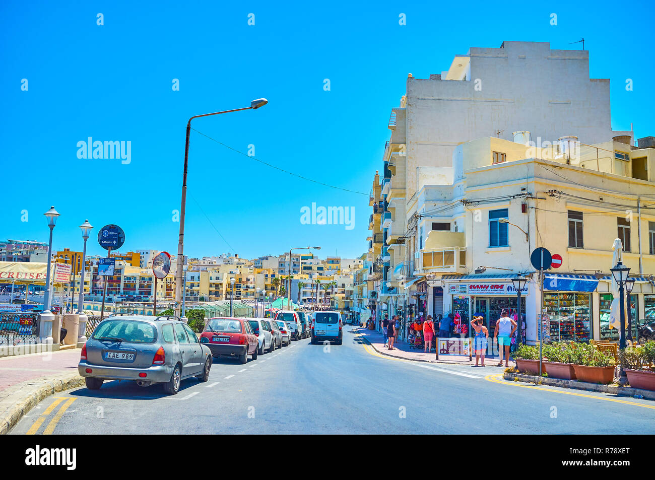 BUGIBBA, MALTA - JUNE 14, 2018: Walking along promenade and streets in the tourist heart of the resort is the best way to explore the offers of souven Stock Photo