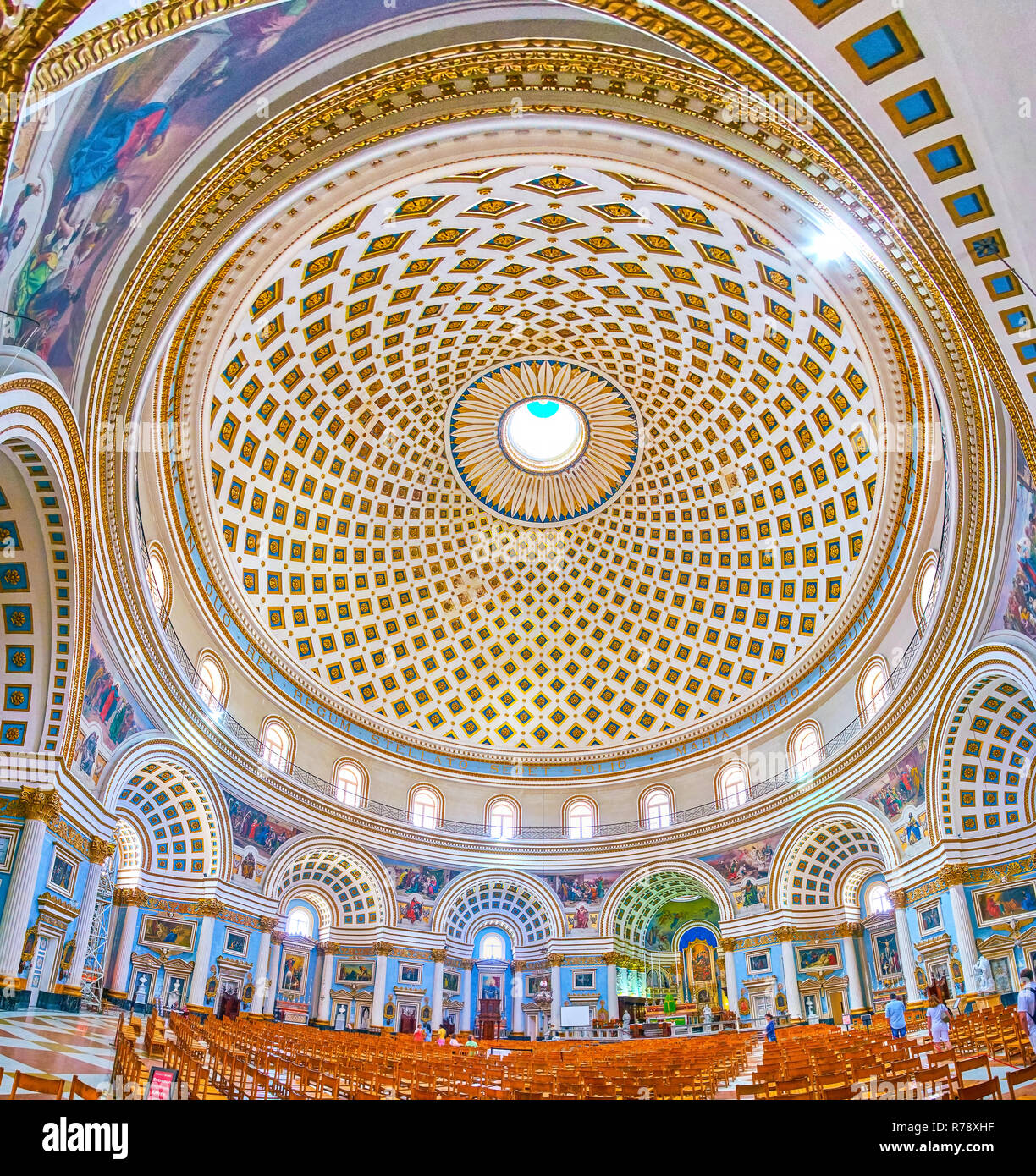 MOSTA, MALTA - JUNE 14, 2018: Interior of huge Basilica of the Assumption of Our Lady (Rotunda) with richly decorated arched niches, beautiful altar a Stock Photo
