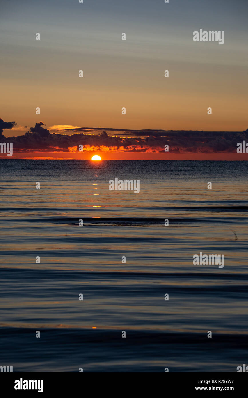 colorful sunset or sunrise in the sea with bright colors and dramatic ...