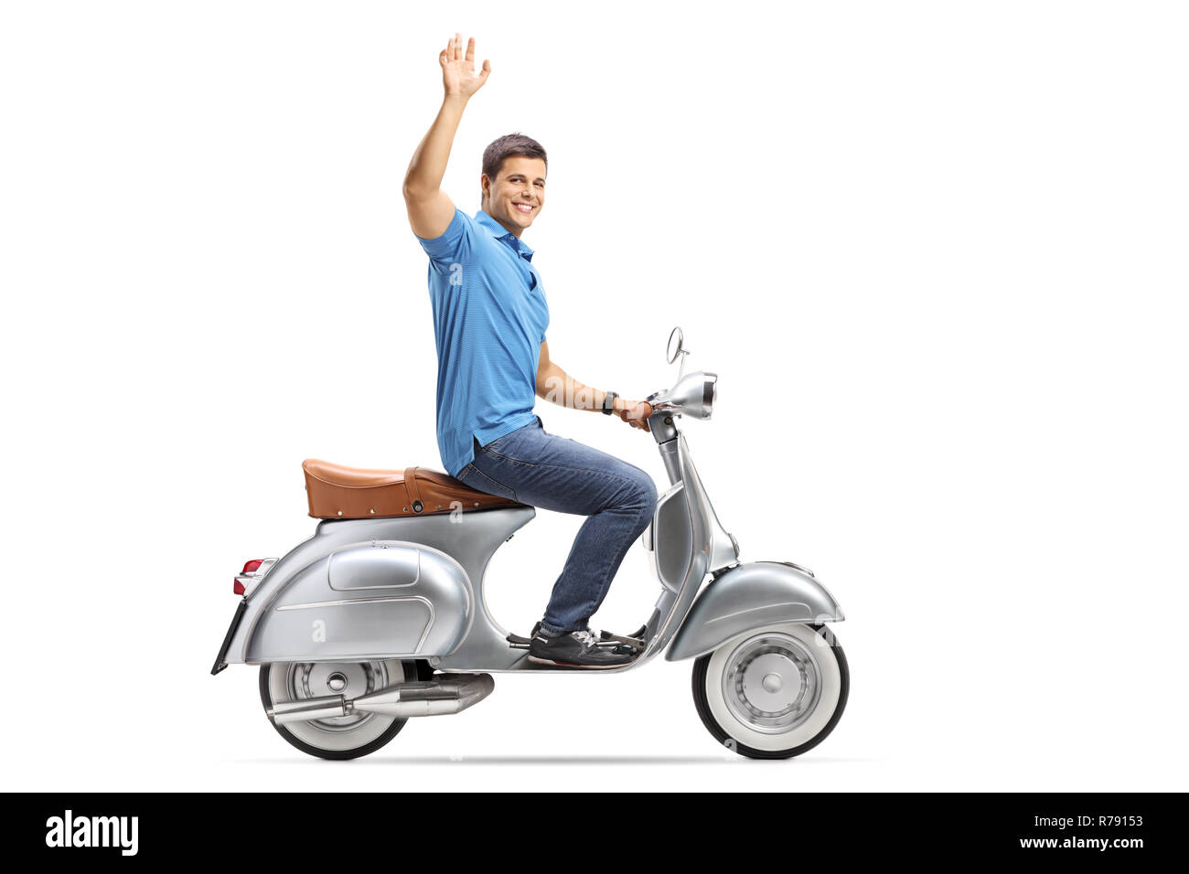 Full length shot of a young man riding a vintage scooter and waving isolated on white background Stock Photo