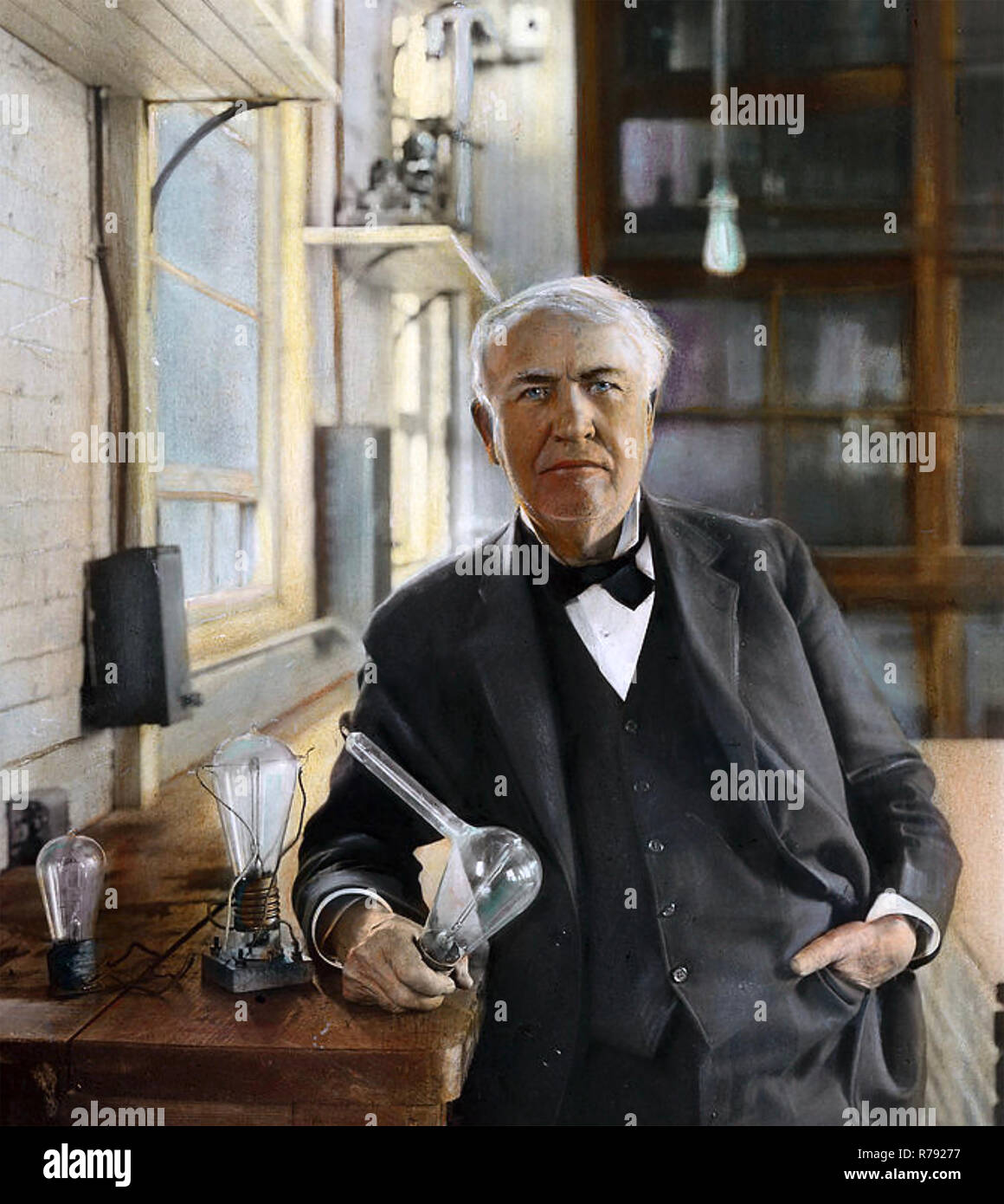 THOMAS EDISON (1847-1931) American inventor and businessman seen with some of his light bulb designs about 1923 in a hand tinted photograph Stock Photo