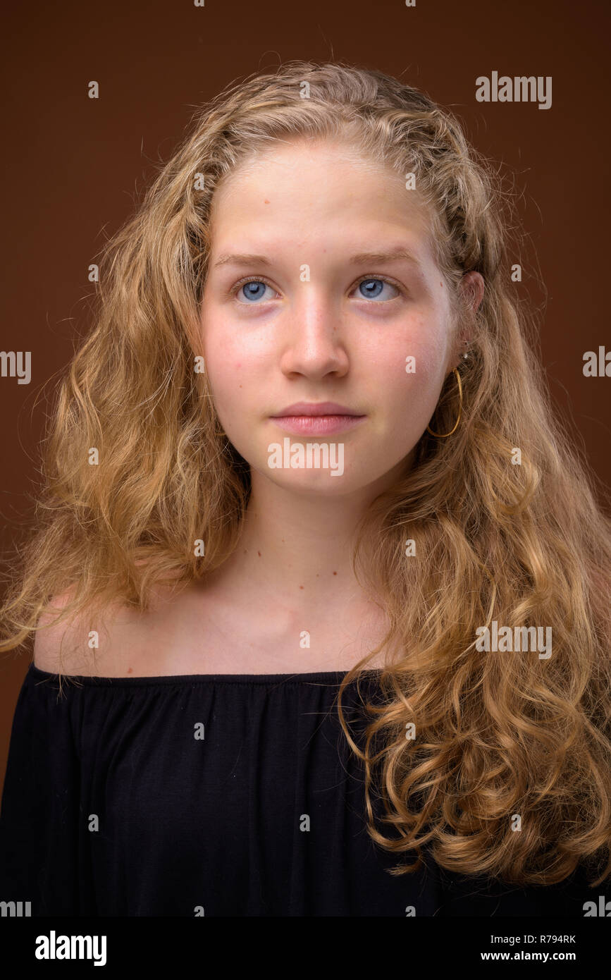 Face of young beautiful blonde teenage girl thinking Stock Photo