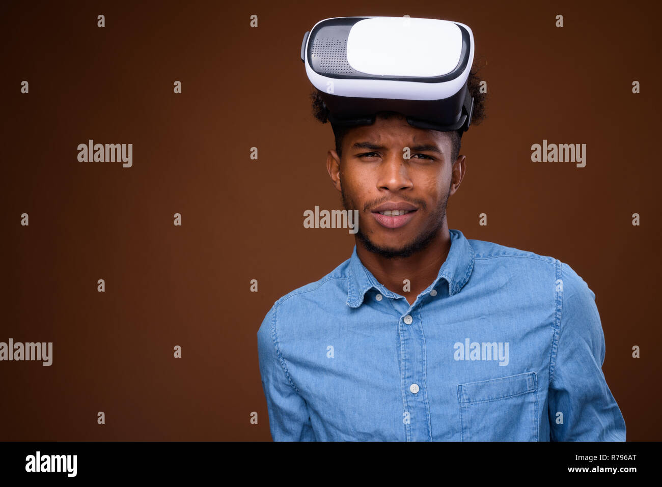 Young handsome African man wearing virtual reality glasses Stock Photo