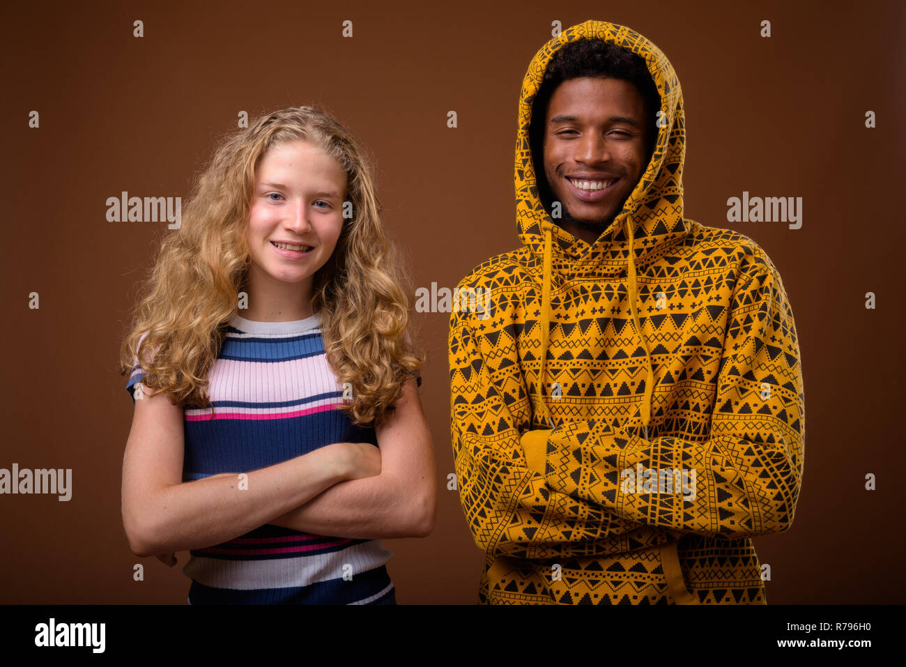 Portrait of young African man and Caucasian teenage girl smiling Stock Photo