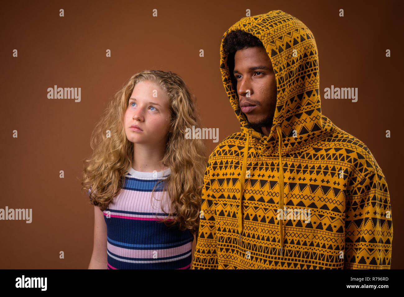 Portrait of young African man and Caucasian teenage girl thinking Stock Photo