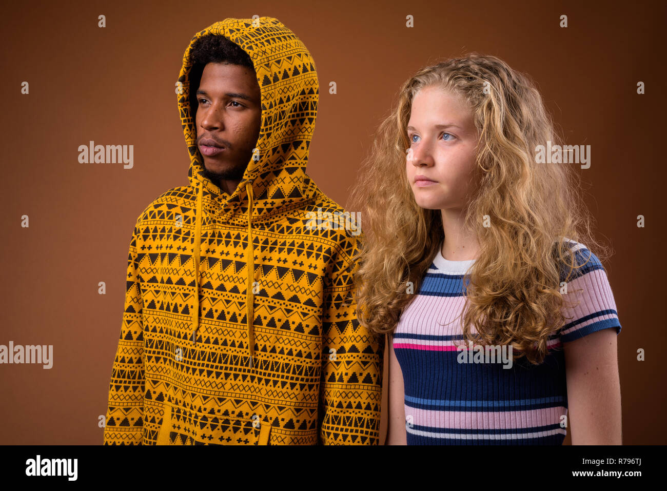 Portrait of young African man and Caucasian teenage girl thinking Stock Photo
