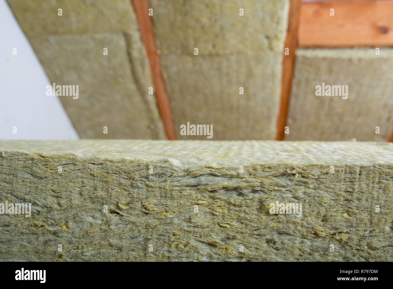 Man Installing Thermal Roof Insulation Layer Using Mineral Wool