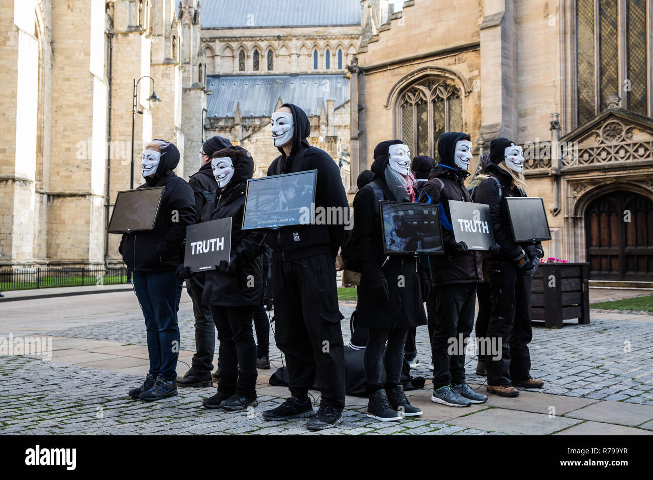 YORK, UK - DECEMBER 8, 2018.  Members of the Cube of Truth Vegan protest group in Guy Fawks masks and protesting about cruelty to animals. Stock Photo