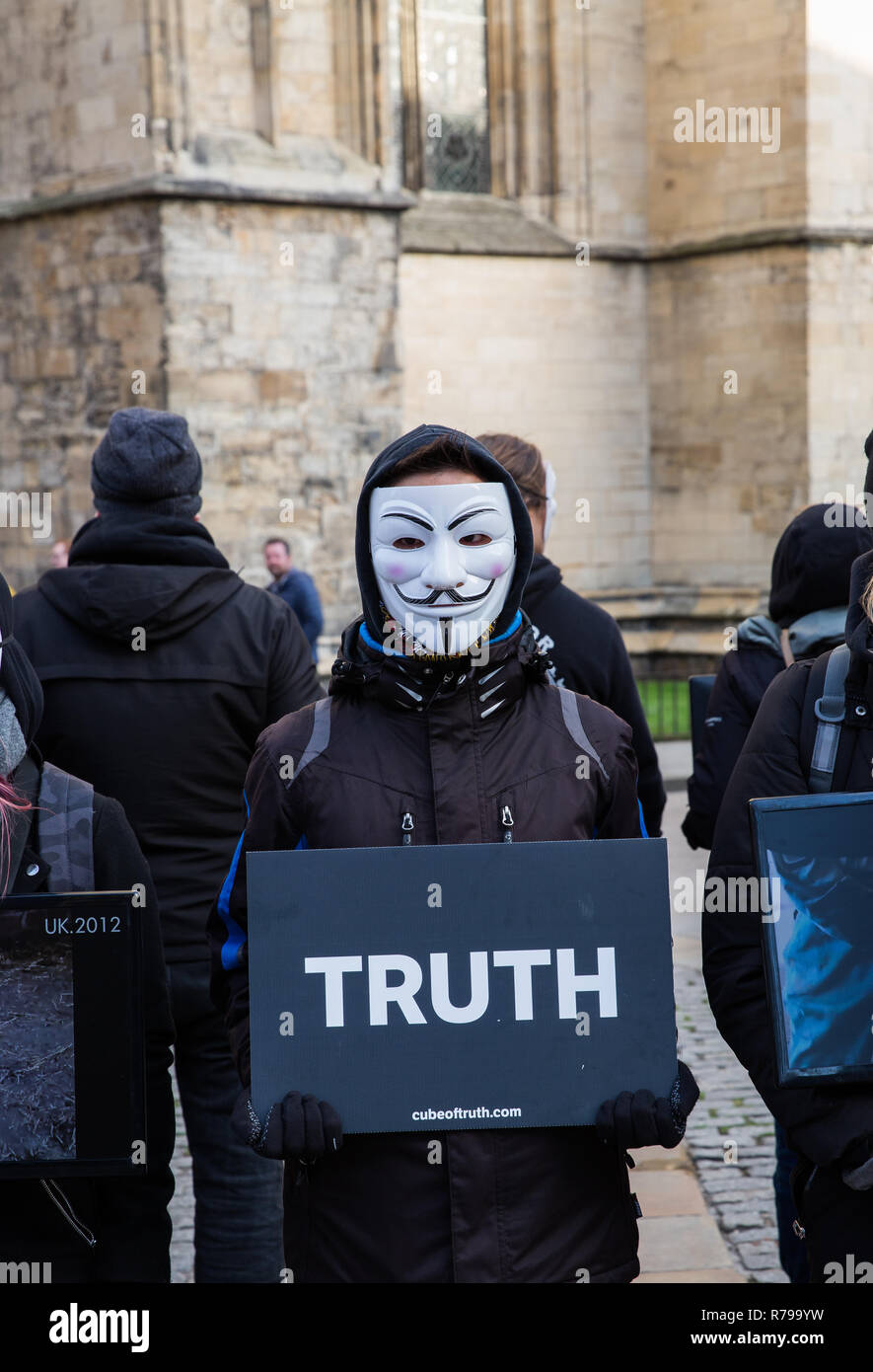 YORK, UK - DECEMBER 8, 2018.  Members of the Cube of Truth Vegan protest group in Guy Fawks masks and protesting about cruelty to animals. Stock Photo