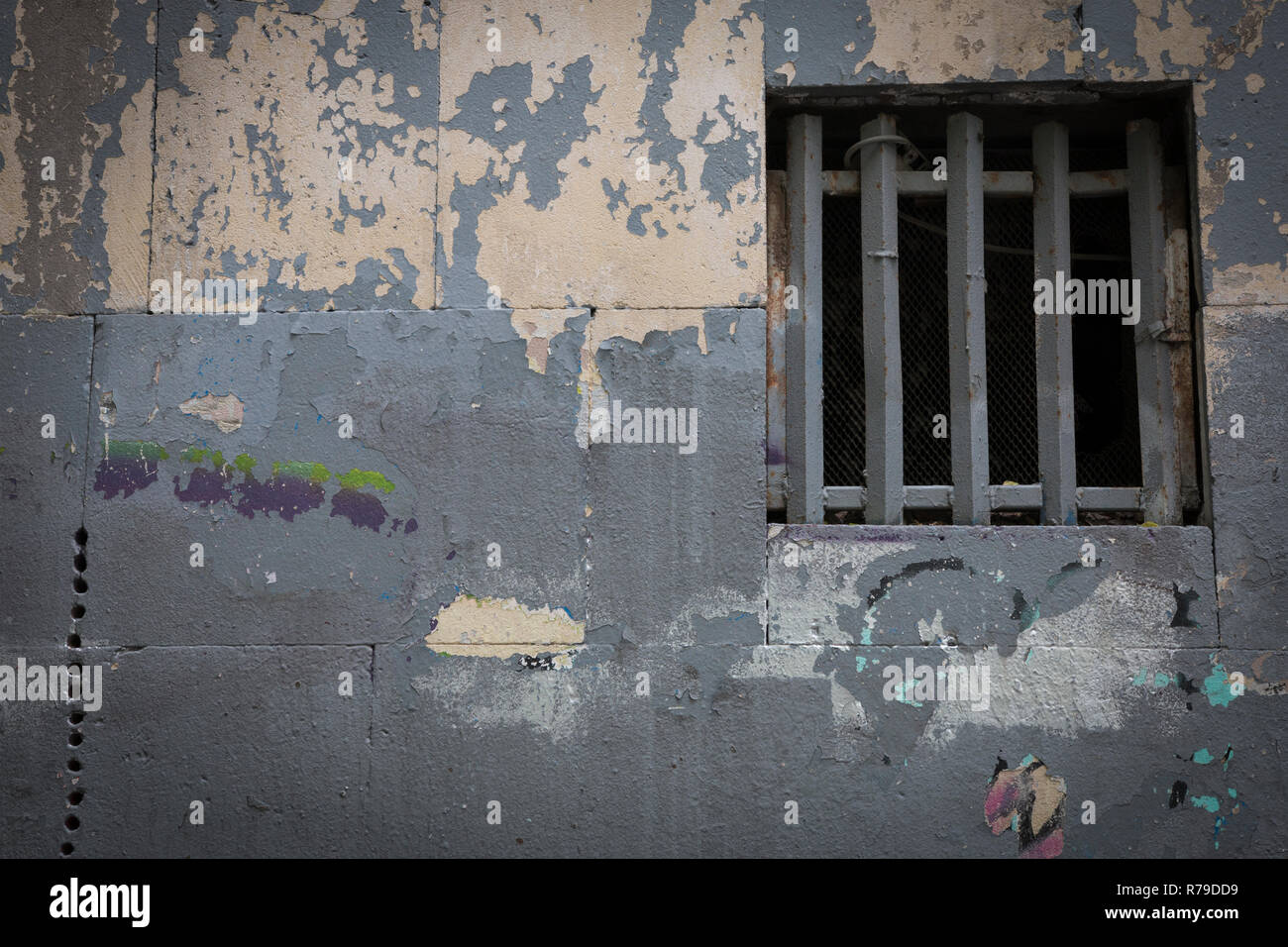 Window with a lattice on a dilapidated wall. The concept of restriction freedom. Human Rights Day Stock Photo