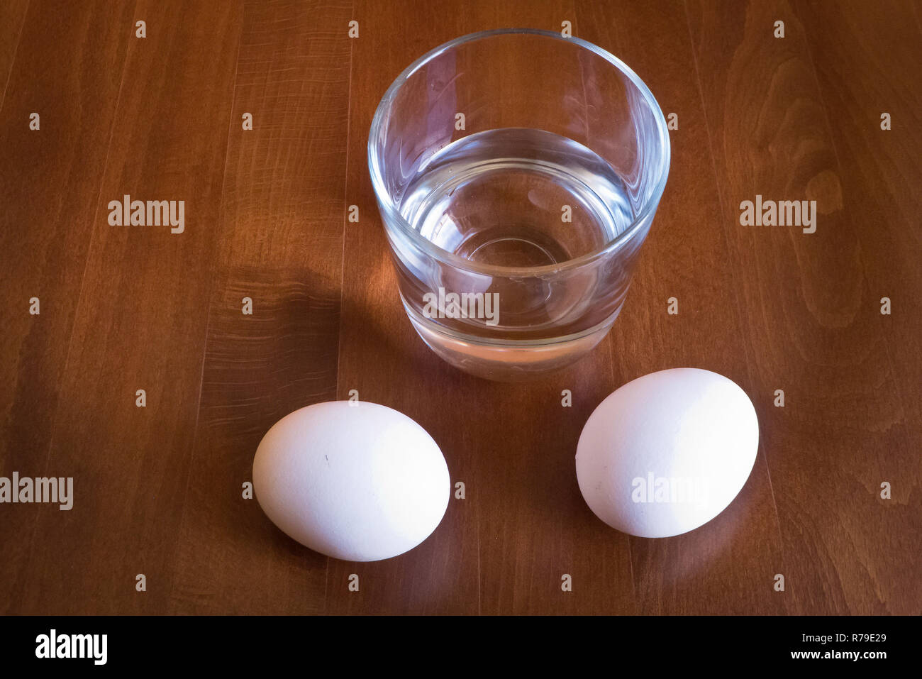 https://c8.alamy.com/comp/R79E29/water-glass-and-two-eggs-on-table-R79E29.jpg