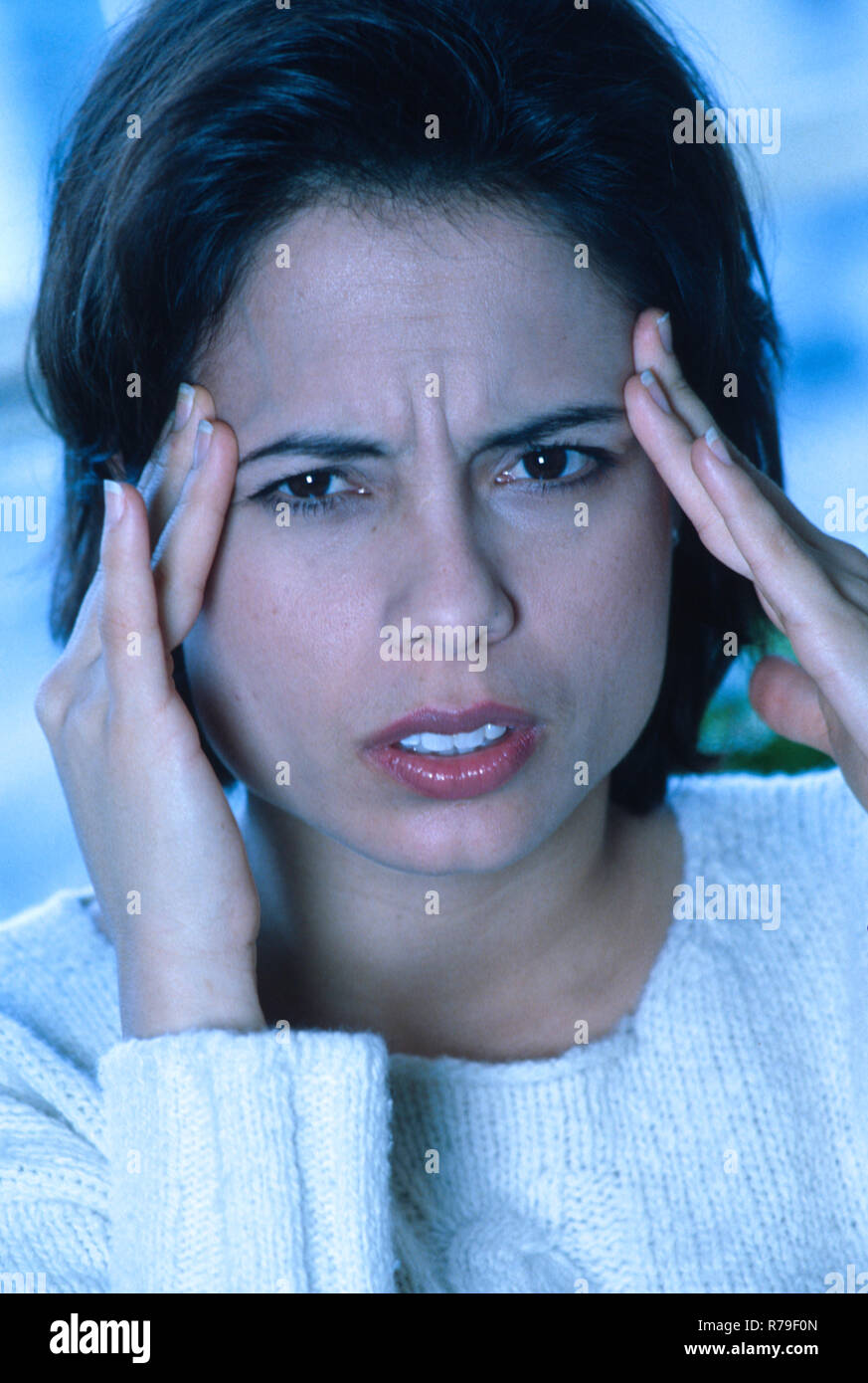 Hispanic woman with a severe headache, USA Stock Photo