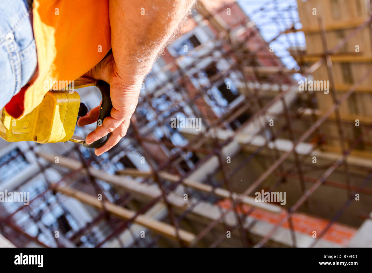 Operator, worker is holding industrial remote, wireless, console to