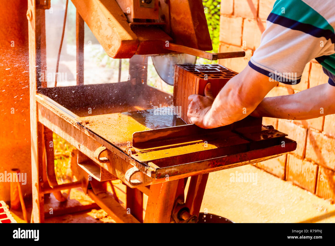 Worker Is Using Power Tool To Makes Clean Precise Cut In Red