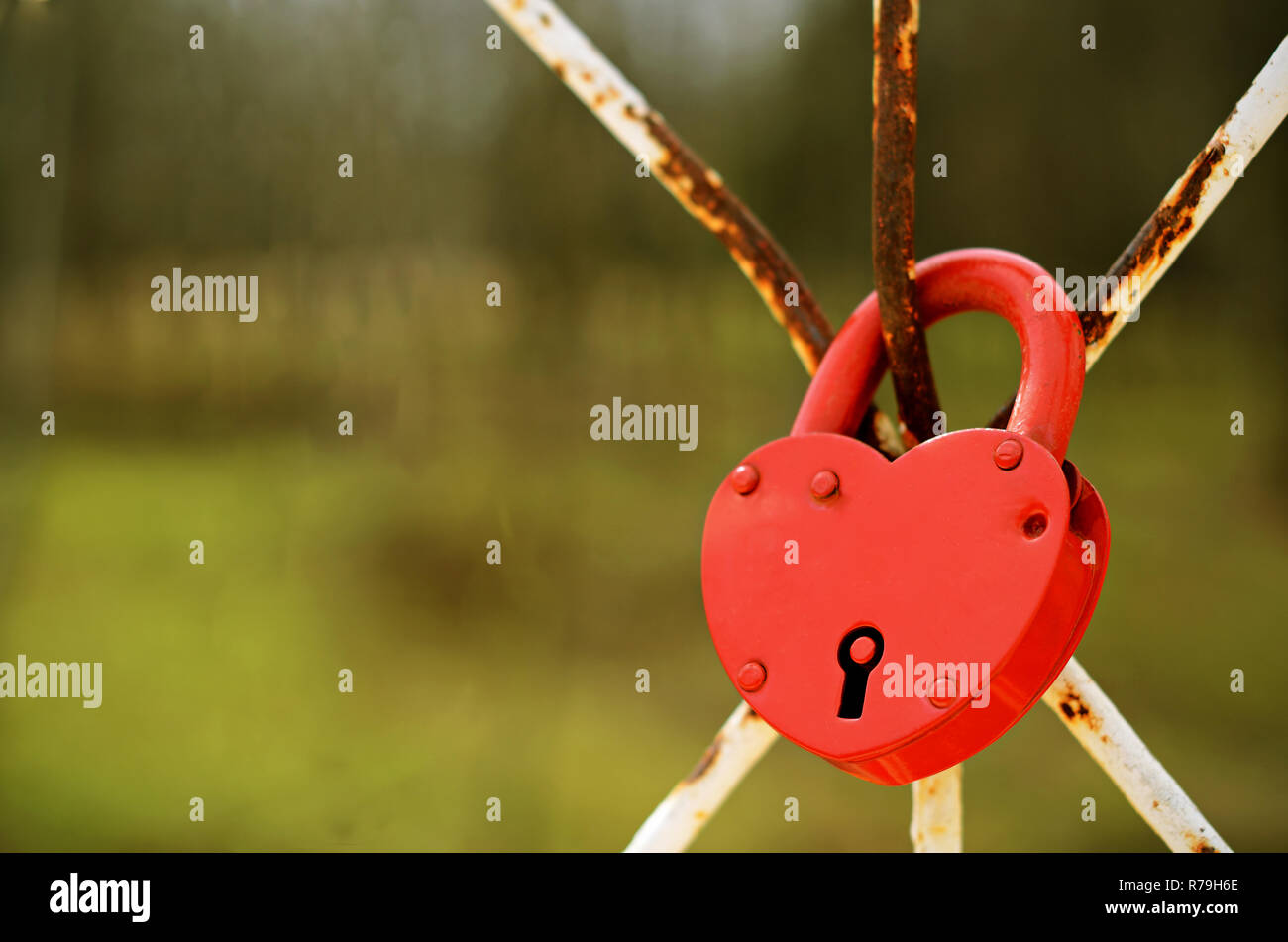 Red heart shaped lock holds the marriage bond by Russian wedding traditions Stock Photo