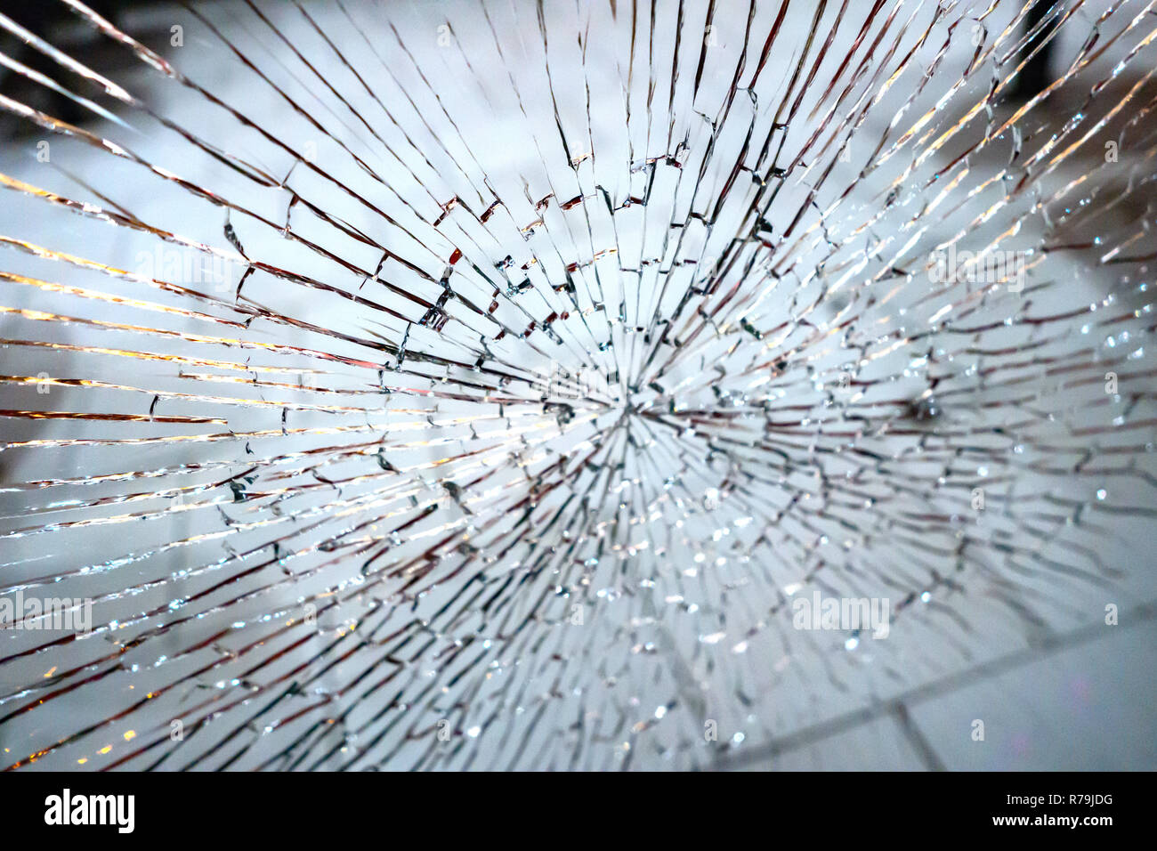 Broken and shattered glass window pane in a shop door Stock Photo