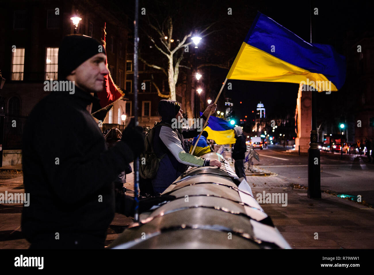 A protester seen holding a flag during the demonstration. Ukrainian expats held an anti-Putin demonstration opposite Downing Street on Whitehall in central London. Tensions between Ukraine and Russia have reached a new height in recent weeks with the Russian seizure of three Ukrainian naval vessels, prompting Ukraine to declare martial law in several border regions. Stock Photo