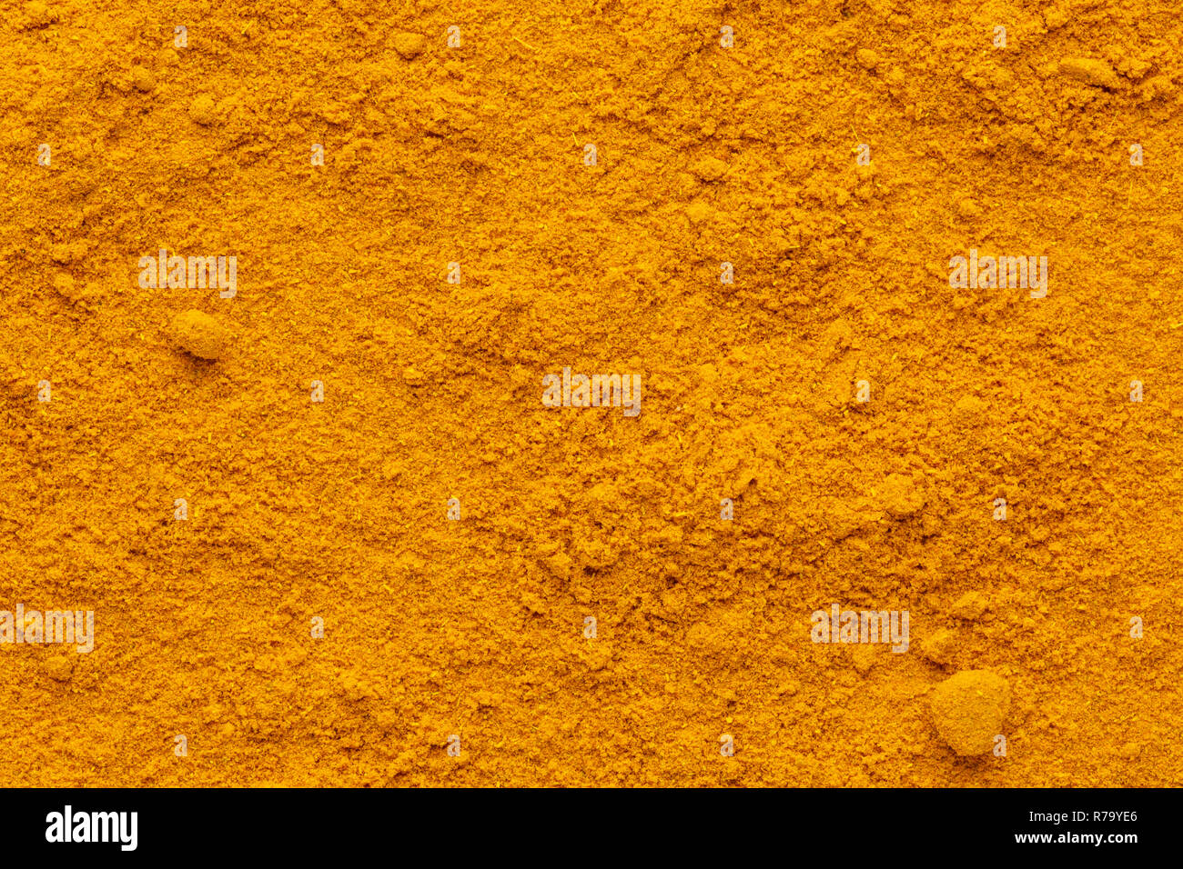 Curry powder ground full frame image background with rough surface, view directly from above. Stock Photo