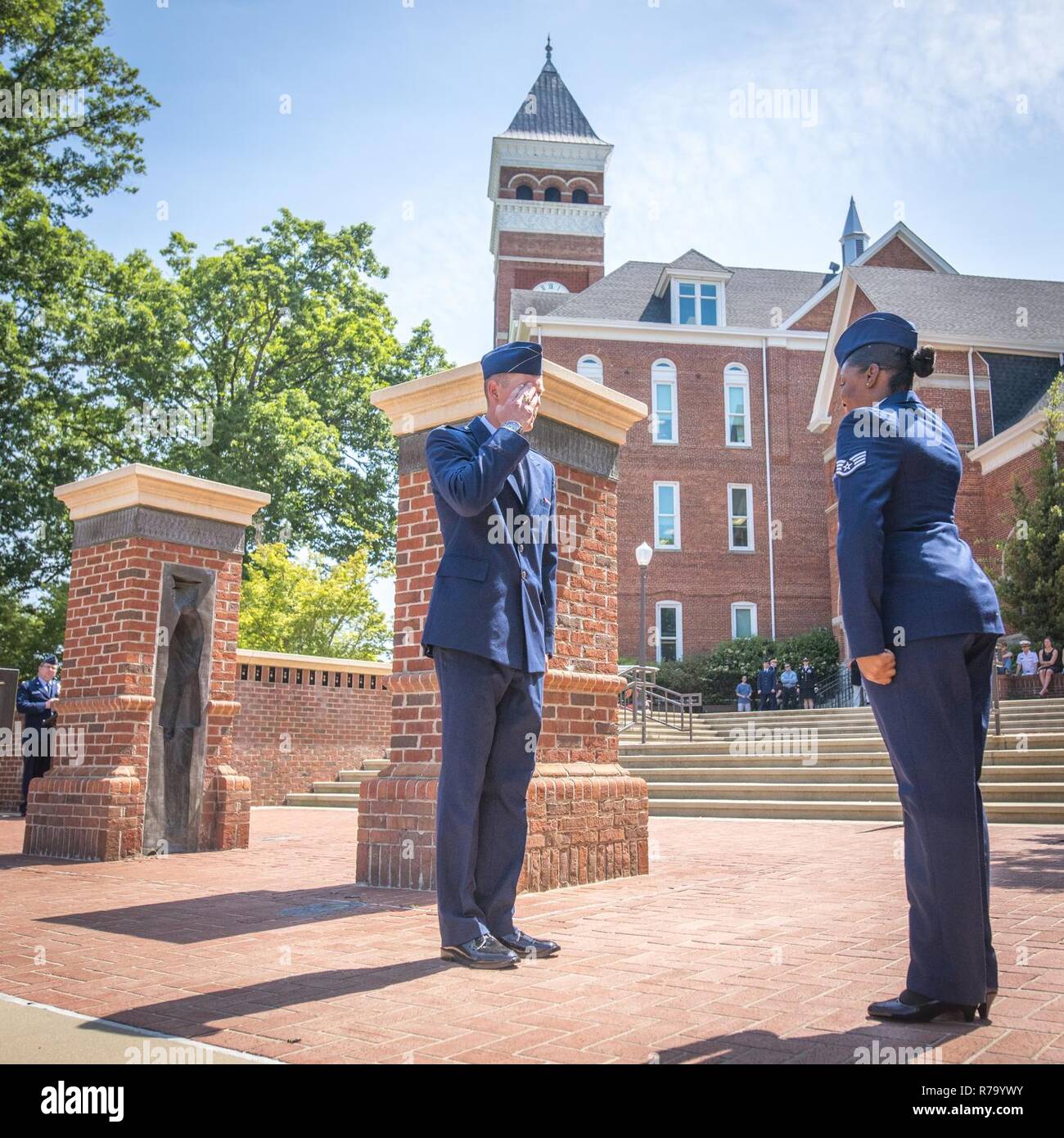 Newly-commissioned U.S. Air Force 2nd Lt. Sean Mac Lain (left) recieves his first salute during a Silver Dollar Ceremony after the Clemson University Reserve Officers’ Training Corps commissioning ceremony, May 10, 2017. Mac Lain was a member of both the 2016 Clemson football National Championship team and the Clemson Pershing Rifles 2016 National Champion drill and ceremony squad. Stock Photo