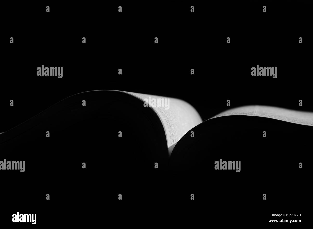 Open book in back light in black and white Stock Photo - Alamy